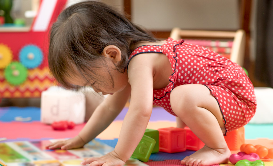 Baby with Book of Bright Colors