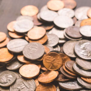 Lots of coins on a table and a stack of quarters