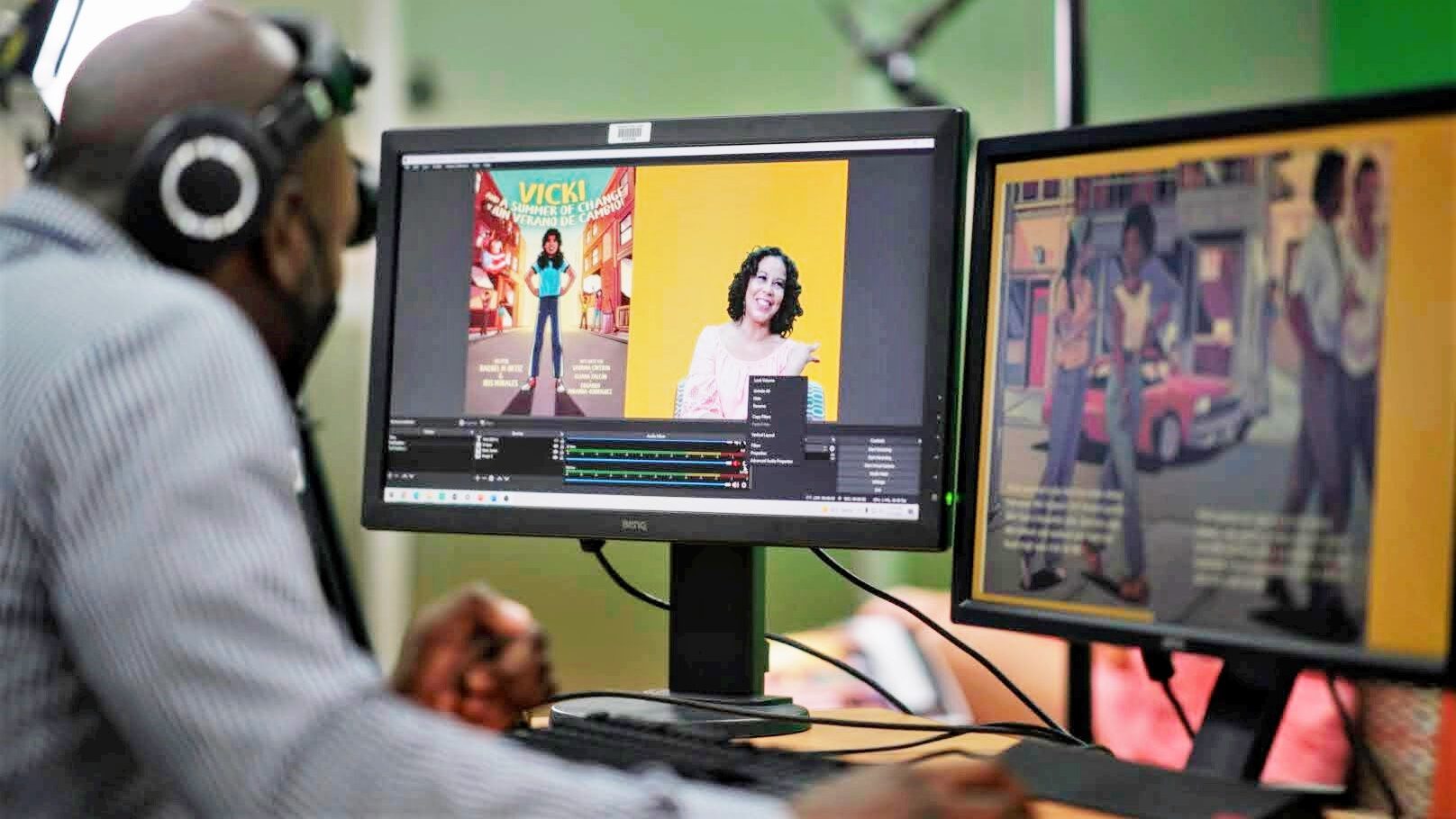 Adult man sitting in front of two computer monitors.